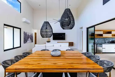 a dining room with a wooden table and chairs at Villa Twilight Tree 5Bdr Nature & Exclusivity in San José Pinilla