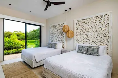 a bedroom with two beds and a large window at Villa Twilight Tree 5Bdr Nature & Exclusivity in San José Pinilla