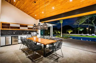 a kitchen and dining room with a wooden table and chairs at Villa Twilight Tree 5Bdr Nature & Exclusivity in San José Pinilla