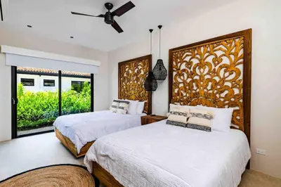 a bedroom with two beds and a large window at Villa Twilight Tree 5Bdr Nature & Exclusivity in San José Pinilla