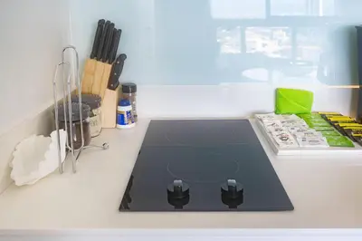 a kitchen counter with a counter top with a stove at Brand new 1 bed loft with spectacular city view in El Empalme