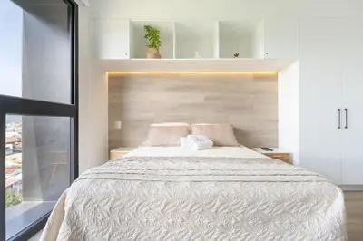 a bedroom with a large bed and a window at Brand new 1 bed loft with spectacular city view in El Empalme