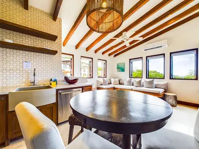 a living room with a table and a kitchen at Calle Cartagena 14C At Catalinas in Playa Danta