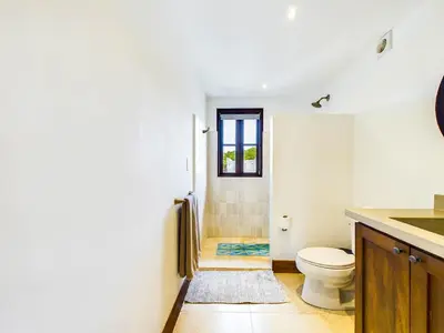 a bathroom with a toilet and a window at Calle Cartagena 14C At Catalinas in Playa Danta