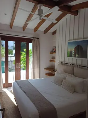 a bedroom with a large white bed with a ceiling at Calle Cartagena 3C At Las Catalinas in Playa Danta