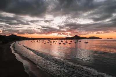 a group of boats in the water at sunset at Calle Cartagena 3C At Las Catalinas in Playa Danta