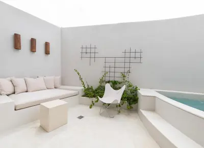 a living room with a white couch and a pool at Calle Cartagena 3C At Las Catalinas in Playa Danta
