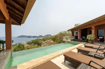 a house with a swimming pool with a view of the ocean at Casa Rosa- Luxury Ocean View 3 Bedroom Home in Brasilito