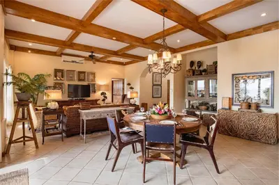 a kitchen and living room with a table and chairs at Casa Rosa- Luxury Ocean View 3 Bedroom Home in Brasilito