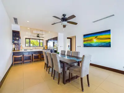 a dining room and kitchen with a table and chairs at 360 Splendor 307A-Ocean View 2 Br Condo-Breakfast in Playa Flamingo