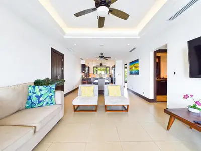 a living room with a couch and a ceiling fan at 360 Splendor 307A-Ocean View 2 Br Condo-Breakfast in Playa Flamingo