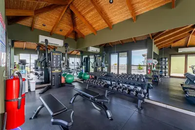 a gym with a lot of equipment in a room at 360 Splendor 404-Ocean View Condo- With Breakfast in Playa Flamingo