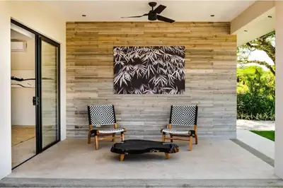 two chairs on a patio with a painting on the wall at 8bd Villa ✪ Top Luxury & Exclusive Villa ✪ up to 24 guests in San José Pinilla