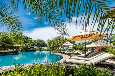 a pool at the resort with chairs and umbrellas at 8bd Villa ✪ Top Luxury & Exclusive Villa ✪ up to 24 guests in San José Pinilla