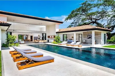 a swimming pool with lounge chairs and a house at 8bd Villa ✪ Top Luxury & Exclusive Villa ✪ up to 24 guests in San José Pinilla