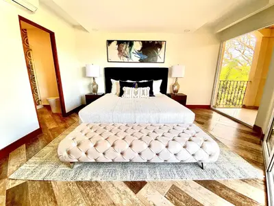 a large bedroom with a large white bed in a room at ✰Upscale 3Bdr condo✰ Incredible amenities ✰Fast wifi in Tamarindo