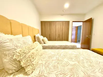 a hotel room with two beds with white sheets at ✰Upscale 3Bdr condo✰ Incredible amenities ✰Fast wifi in Tamarindo