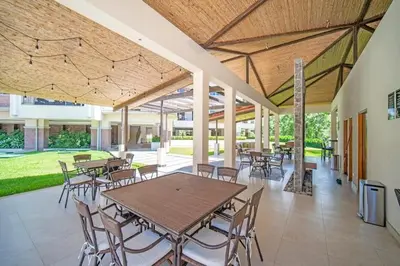 a patio with tables and chairs in a building at ✰Upscale 3Bdr condo✰ Incredible amenities ✰Fast wifi in Tamarindo