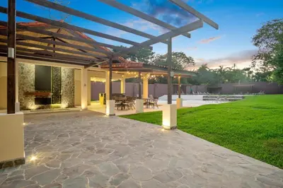an outdoor patio with a wooden pergola at ✰Upscale 3Bdr condo✰ Incredible amenities ✰Fast wifi in Tamarindo