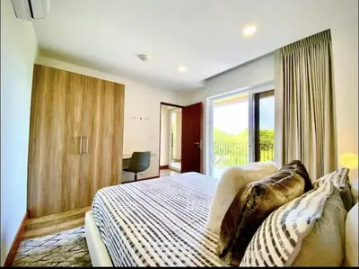 a bedroom with a bed and a large window at ✰Upscale 3Bdr condo✰ Incredible amenities ✰Fast wifi in Tamarindo