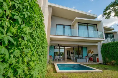 a house with a swimming pool in front of it at Private Pool Townhouse with Partial Ocean View - Aromo - Reserva Conchal in Playa Conchal