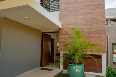 a plant in a pot in front of a building at Private Pool Townhouse with Partial Ocean View - Aromo - Reserva Conchal in Playa Conchal