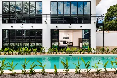 an exterior view of a house with a swimming pool at House of Nomad - Adults only in Tamarindo