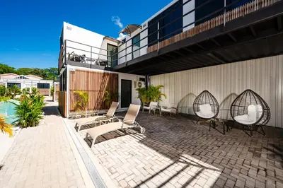 a patio with chairs and a building at House of Nomad - Adults only in Tamarindo