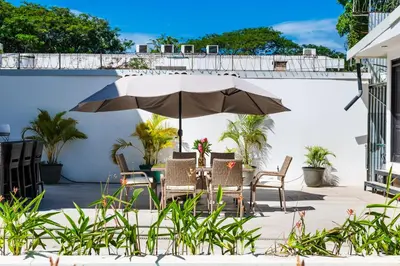 a table and chairs under an umbrella on a patio at House of Nomad - Adults only in Tamarindo