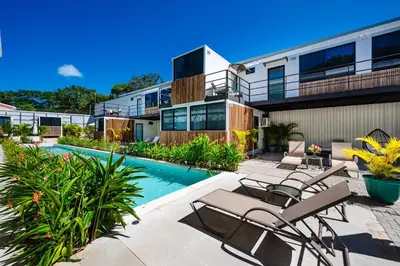 an exterior view of a building with a swimming pool at House of Nomad - Adults only in Tamarindo
