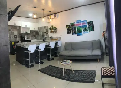 a living room with a bar and a couch at Casa Bosque GuestHouse & Car Rental - Free SJO Airport Shuttle in Desamparados