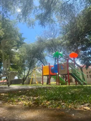a playground with a slide in a park at Casa Bosque GuestHouse & Car Rental - Free SJO Airport Shuttle in Desamparados