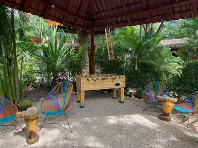 a ping pong table and chairs under a pavilion at Casa Tropical Playa Grande in Cuajiniquil