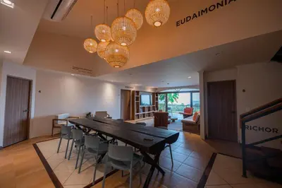 a dining room with a long table and chairs at Marala Hotel in Esterillos