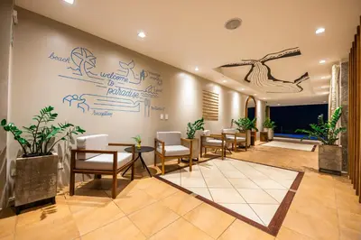 a waiting room with chairs and writing on the wall at Marala Hotel in Esterillos