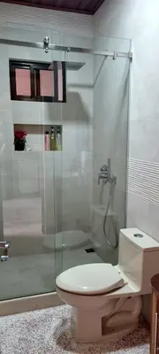 a bathroom with a toilet and a glass shower at La Torre Azul in Alajuela City