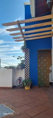 a blue building with a staircase and plants on it at La Torre Azul in Alajuela City