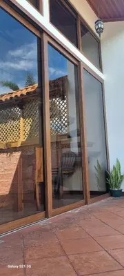 a glass window of a house with a bench in it at La Torre Azul in Alajuela City