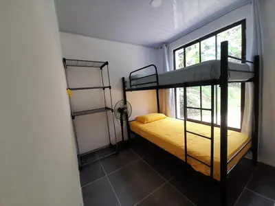 a room with two bunk beds and a window at Mi casita in Montezuma