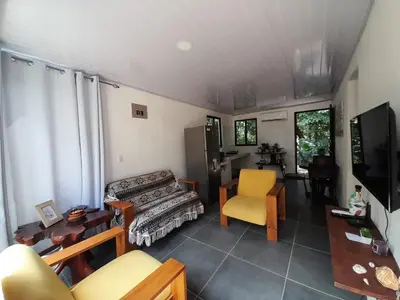 a living room with a couch and a chair at Mi casita in Montezuma