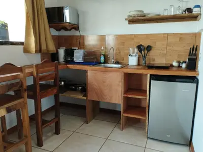a kitchen with a wooden counter with a sink and a counter at Siary Aparment con vista 3 in Monteverde Costa Rica