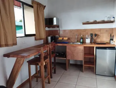 a kitchen with a wooden table and a counter top at Siary Aparment con vista 3 in Monteverde Costa Rica
