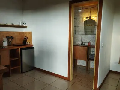 a kitchen with a counter and a sink and a refrigerator at Siary Aparment con vista 3 in Monteverde Costa Rica