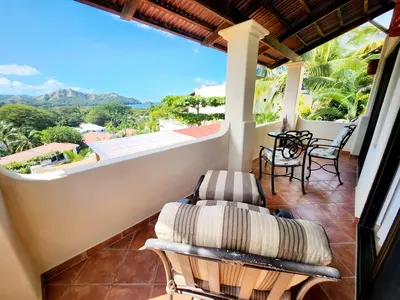 a balcony with chairs and a view of the mountains at Amazing Oceanview Private Villa Rooftop Terrace Walk to Beach in Coco