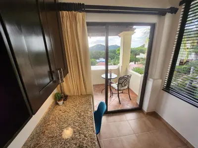 a room with a balcony with a table and a view at Amazing Oceanview Private Villa Rooftop Terrace Walk to Beach in Coco