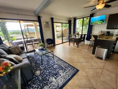 a living room with a couch and a table at Amazing Oceanview Private Villa Rooftop Terrace Walk to Beach in Coco