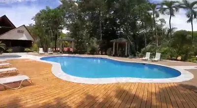 a large swimming pool with chairs around it at El Sueno Tropical in Carrillo
