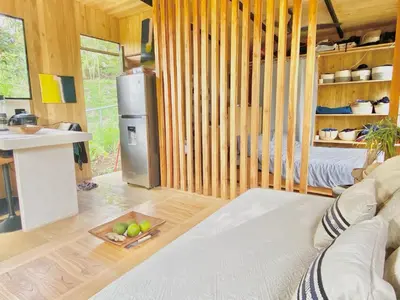 a living room with a couch and a bowl of fruit at CASA BÚHO in Santa Teresa Beach