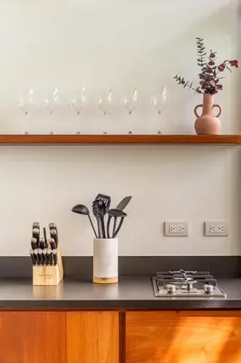 a kitchen counter with wine glasses and a stove at NAIA OCEANVIEW STUDIO in Carmen