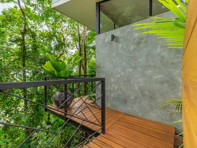 a room with a view of the forest from the balcony of a house at NAIA OCEANVIEW STUDIO in Carmen